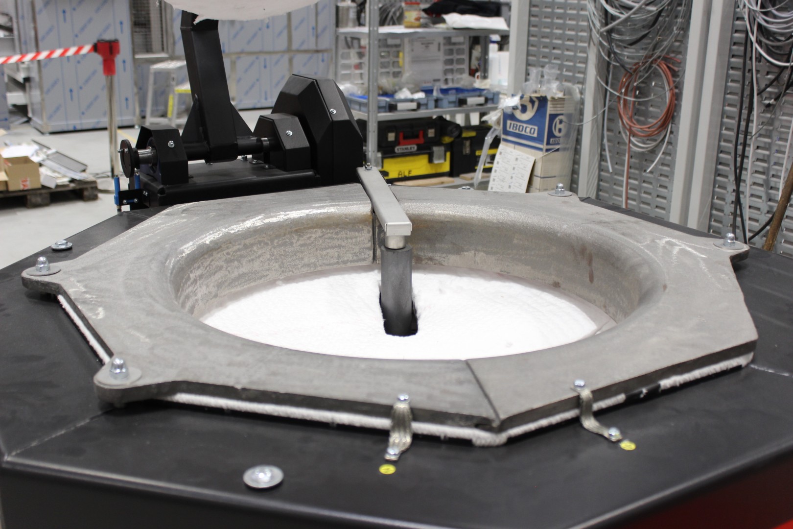 Charge thermocouple in a protective tube for measuring the temperature of material inside a crucible furnace